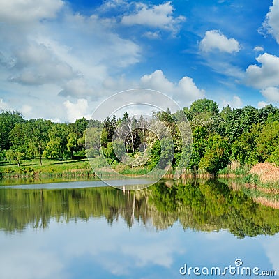 Picturesque lake, forest on the banks and sky Stock Photo