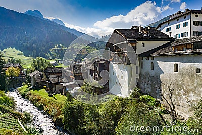 Picturesque mountain village with white stone houses and stone roofs in the Swiss Alps Editorial Stock Photo