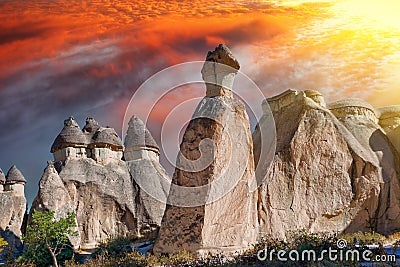 Picturesque natural stone statues against a red sky at sunset in Cappadocia Stock Photo