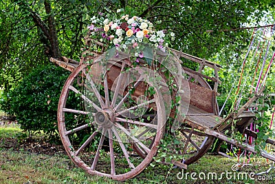 Picturesque old wooden ancient cart decorated with flower for a wedding Stock Photo