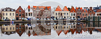 Picturesque panorama with beautiful traditional houses reflection in canal, Haarlem, Holland Editorial Stock Photo