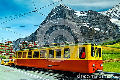 Picturesque place with mountains and old tourist train, Grindelwald, Switzerland Stock Photo
