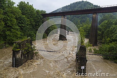 Two bridges over a stormy mountain river Stock Photo