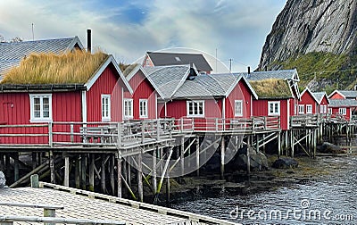 red cabins on stilts at the edge of the sea in the village Reine in Lofoten Islands North Norway Stock Photo