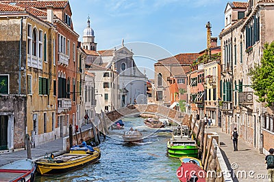 Picturesque Scene from Venice with stone bridges over the water canals and the boat traffic Editorial Stock Photo