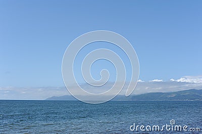 Picturesque seashore with beach and ocean waves and horizon on a sunny day with clear blue sky and calm ocean in Hokkaido, Japan Stock Photo