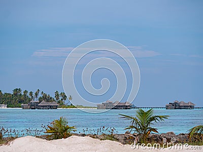 Picturesque shot of empty wooden oceanfront bungalows in the scenic Maldives. Stock Photo