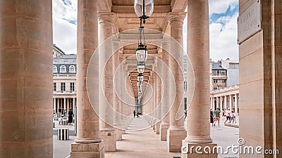 Picturesque stone walkway lined with a row of classical-style lanterns in Palais-Royal, Paris. Editorial Stock Photo