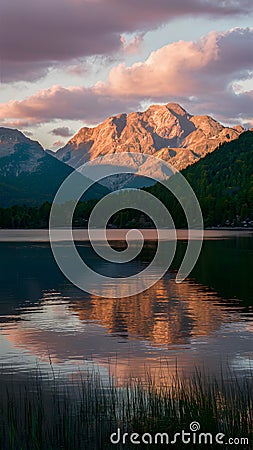 Picturesque sunset scene bathes the lake in warm, golden hues Stock Photo