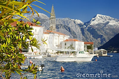 Picturesque view of ancient city of Perast, Montenegro. Boy in old medieval little town with red roofs and majestic mountains on Stock Photo