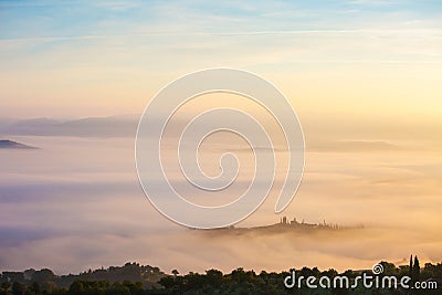 .Picturesque view of countryside of Tuscany in the light of the rising sun in foggy morning, Italy Stock Photo