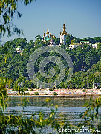 A picturesque view of the golden domes of church temples on the background of the city embankment Editorial Stock Photo