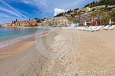 Menton. Antique multi-colored facades of medieval houses on the shore of the bay. Stock Photo
