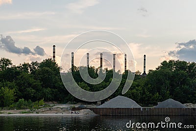 Yaroslavl region, Russia, July 8, 2023. Industrial zone with huge pipes on the river bank. Editorial Stock Photo