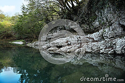 Picturesque view of rocky pond shore in park Stock Photo