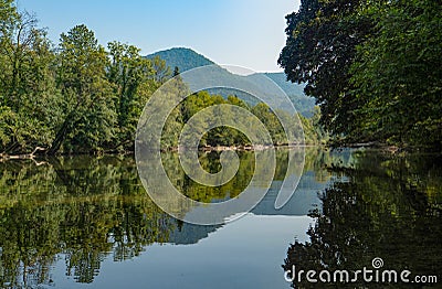 Picturesque view of the tranquil Kolpa river flowing through the lush forests. Stock Photo