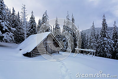 Picturesque winter landscape with huts, snowy mountains and forest. Stock Photo