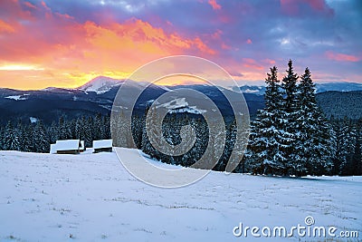 Picturesque winter landscape with huts, snowy mountains. Stock Photo