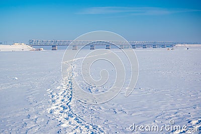 Picturesque winter scenery with road bridge across the Dnieper river near Cherkasy, Ukraine Stock Photo