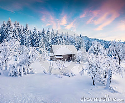 Picturesque winter sunrise in Carpathian village with snow cower Stock Photo