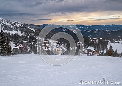 Picturesque winter windy and cloudy morning alps. View of famous Ukrainian Dragobrat ski resort from Svydovets mountain ridge Stock Photo