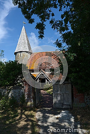 St Johns Church entrance and spire. Piddinghoe, East Sussex. UK Editorial Stock Photo