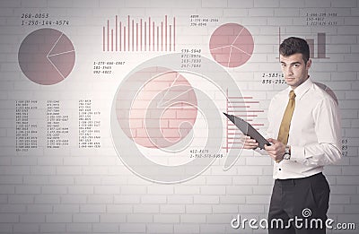 Pie charts and numbers on wall with salesman Stock Photo