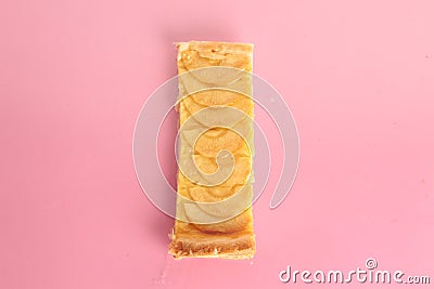 Piece of an apple pie on a pink background Stock Photo