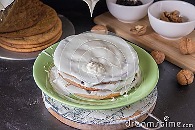piece baked cakes for homemade honey cake are pouring white butter cream Stock Photo