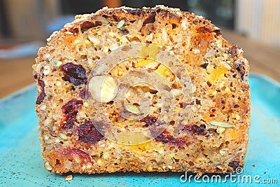 A piece of bread with dried fruits on blue plate Stock Photo