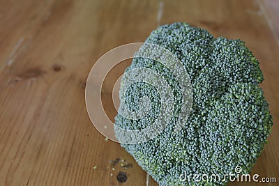 Piece of broccoli on rustic wooden table Stock Photo