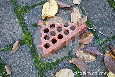 piece of broken red brick on the ground Stock Photo