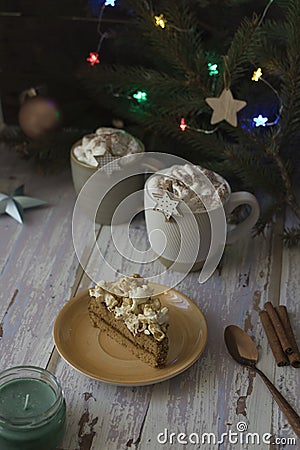 piece of cake and hot chocolate on rustic table on christmas Stock Photo