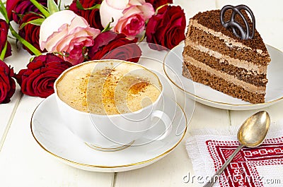 Piece of chocolate cake, cappuccino, flowers on table Stock Photo