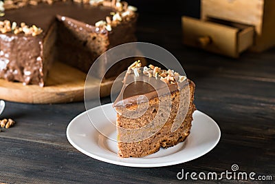 Piece of chocolate cake on a white plate on wooden. Traditional austrian cake. Sacher cake. Apricot pie. Breakfast concept. Coffee Stock Photo