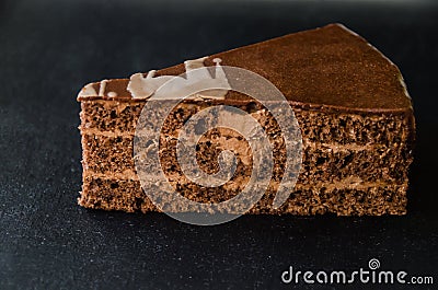 A piece of cake is isolated on a dark background Stock Photo