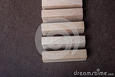 Piece of domino made of wood on dark background Stock Photo