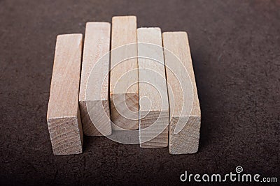 Piece of domino made of wood on dark background Stock Photo