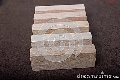 Piece of domino made of wood on dark background Stock Photo