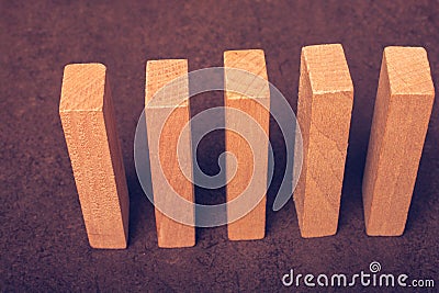 Piece of domino made of wood on dark background Stock Photo