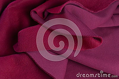 Piece of fabric lies in beautiful waves. layers of French terry pink amaranth textile Stock Photo