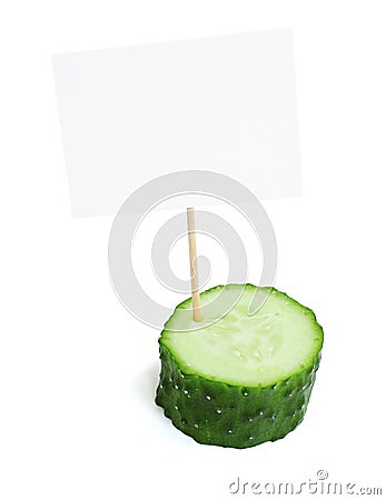 Piece of a fresh cucumber with blank cardboard information tag Stock Photo