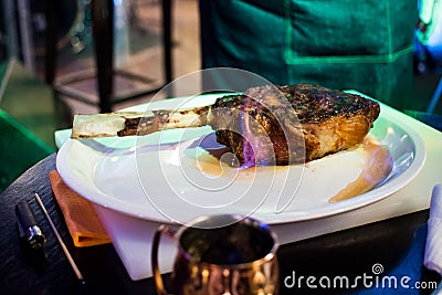 A piece of fried meat on a bone with tongues of flame Stock Photo