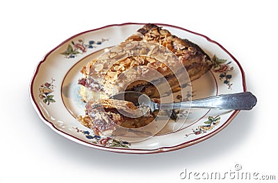 Piece of handmade cake with almonds and currant jam isolated on white Stock Photo
