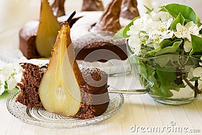 Piece of homemade chocolate cake with pears decorated pear blossom Stock Photo