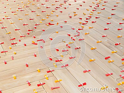 Piece of leveling and spacing plugs on tile floor installation stage Stock Photo