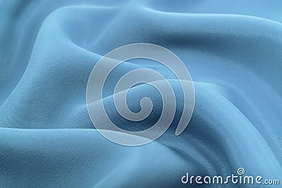 A piece of material with blue or turquoise folds. Silk fabric with oxen and rumples Stock Photo