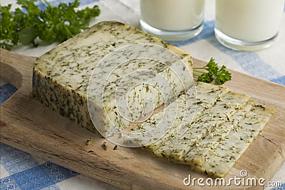 Piece of mature Dutch goats cheese with herbs Stock Photo