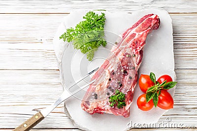 Piece of meat pork brisket ribs spatula seasoned with salt and pepper and sprig of basil Stock Photo