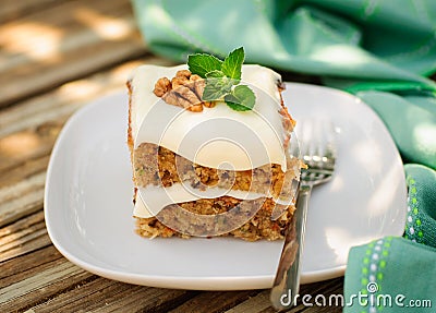 A Piece of Moist Zucchini and Walnut Cake with Cream Cheese Frosting Stock Photo